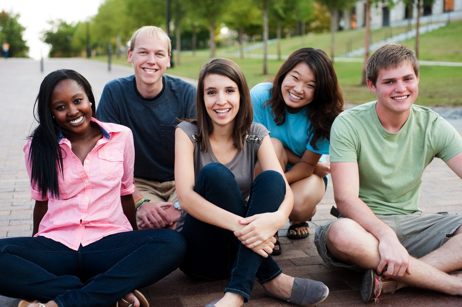 Diverse group of friends outside smiling together in special ed